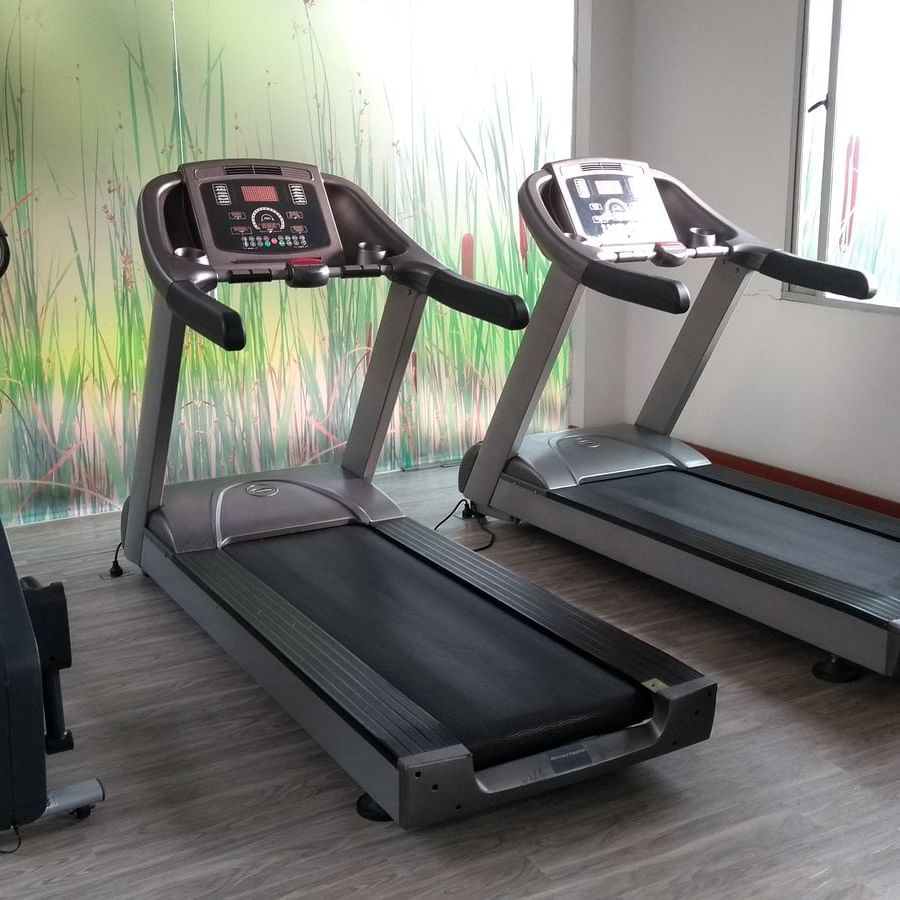 Exercise machines in a fitness center at Factory Green Hotel
