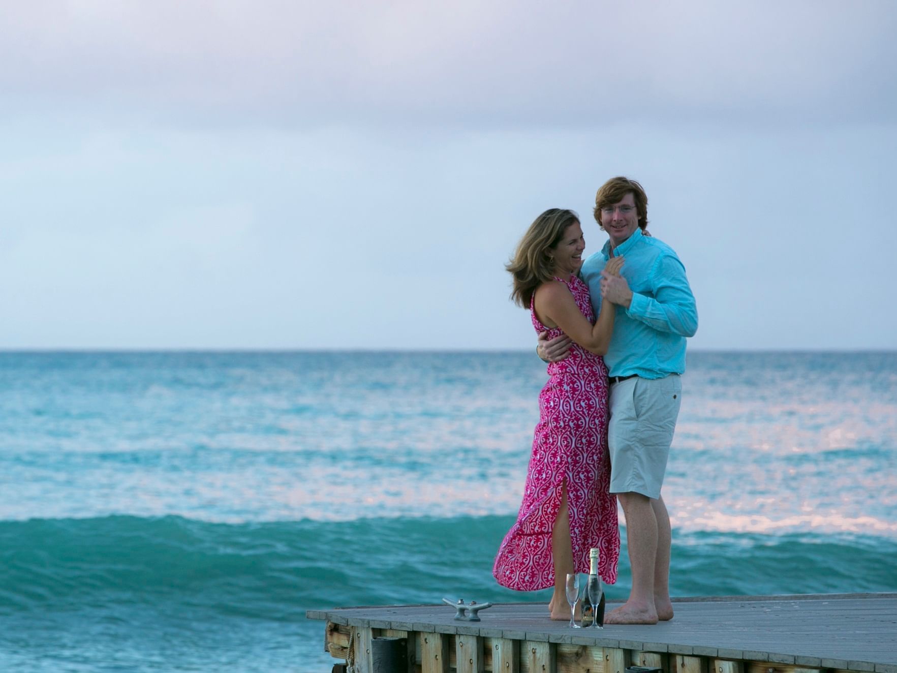 Couple hugging each other on a pier near The Buccaneer