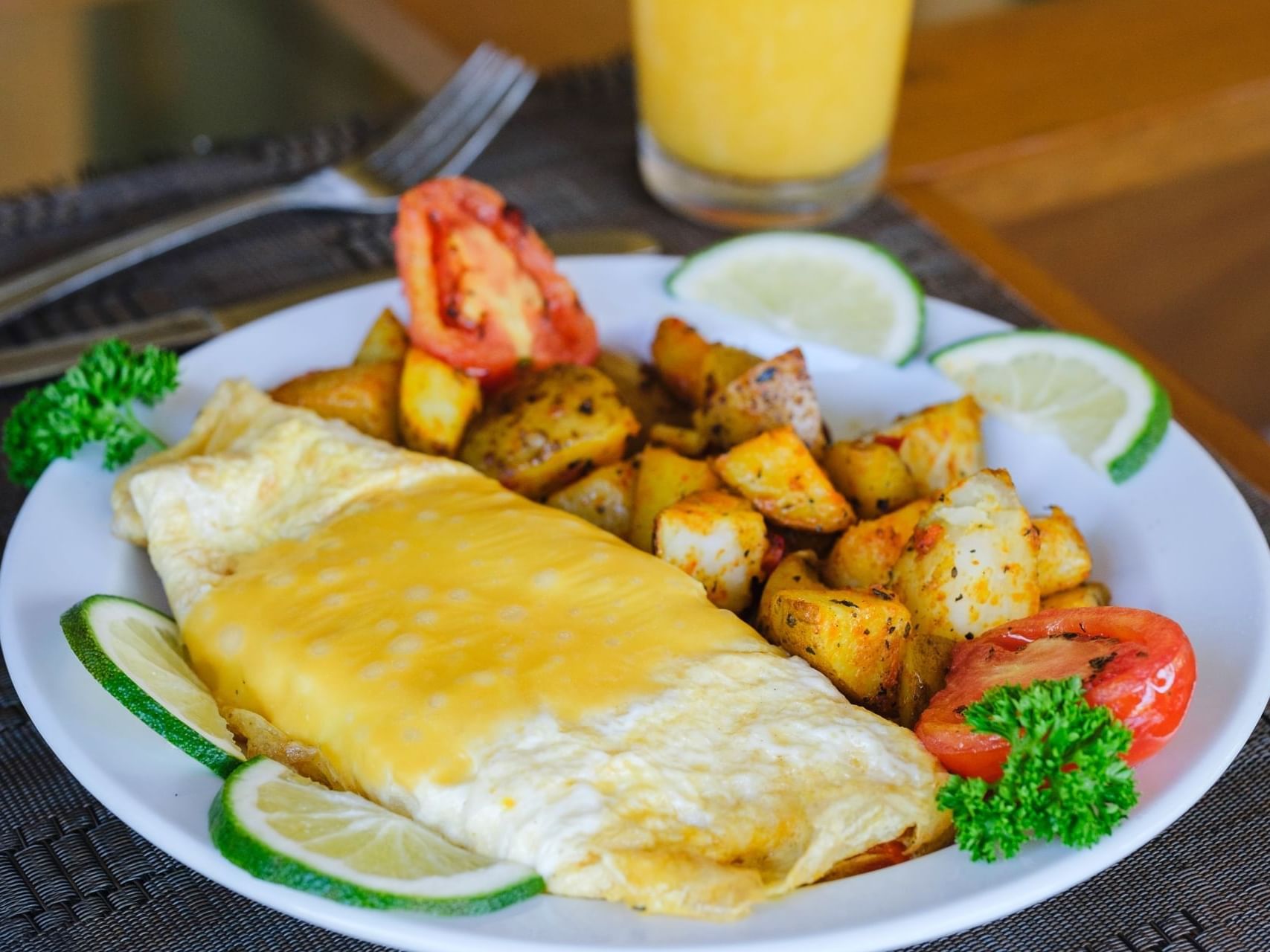 Cheese omelette with seasoned potatoes, tomato, and lime served in La Abigail Restaurant at Las Olas Beach Resort