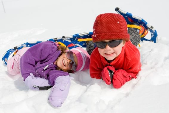 Two kids snowshoeing near Stein Eriksen Lodge Deer Valley