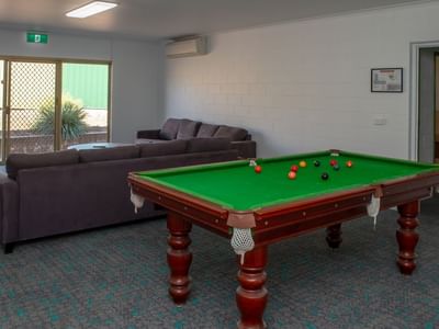 Comfortable lounge with billiard table and couch at La Trobe University - Orde House.