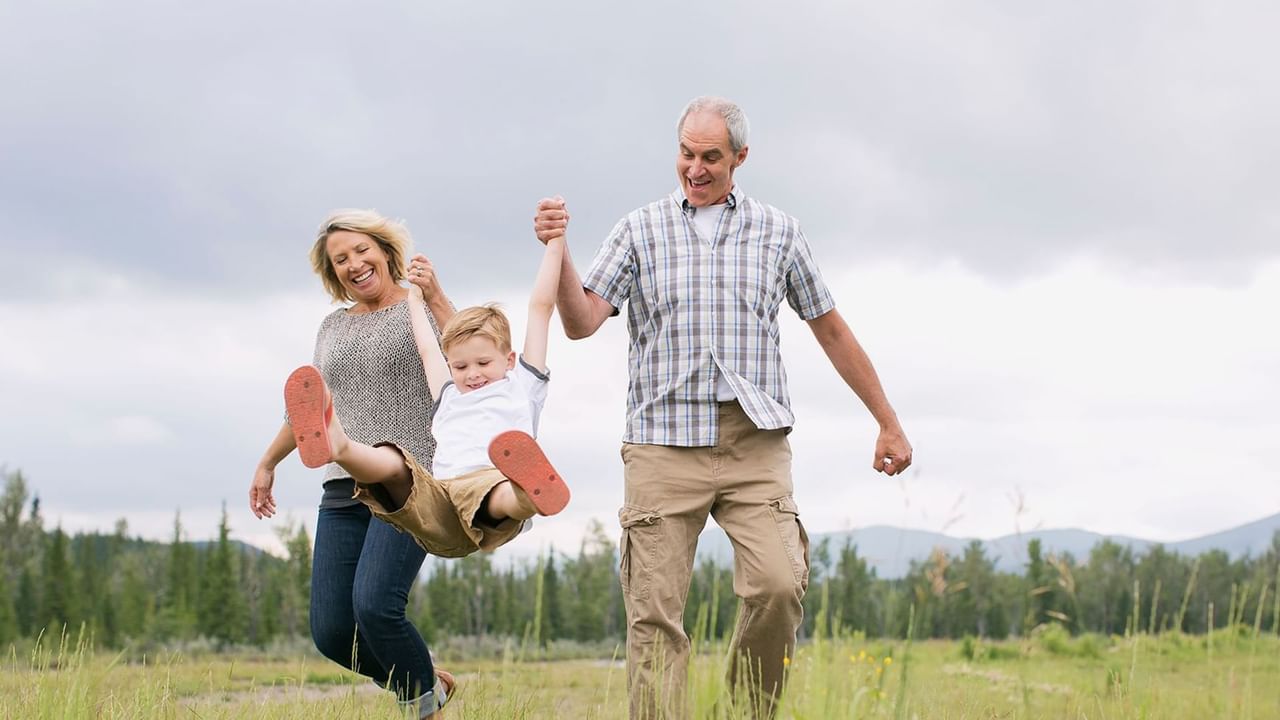 Grandparents with grandchildren playing in the field