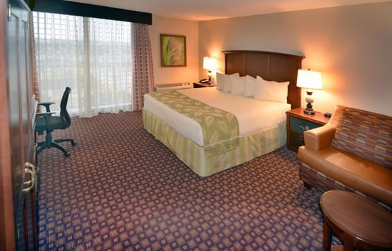 King bed & work desk in Deluxe King Room at Rosen Inn Universal