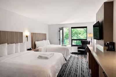 TV & lounger by the beds in Standard Two Queen Beds at Temple Gardens Hotel & Spa