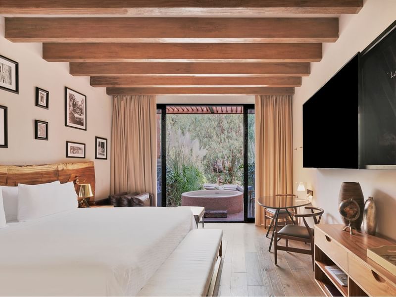 King bed and TV with work area in Wellness Suite at Live Aqua San Miguel de Allende