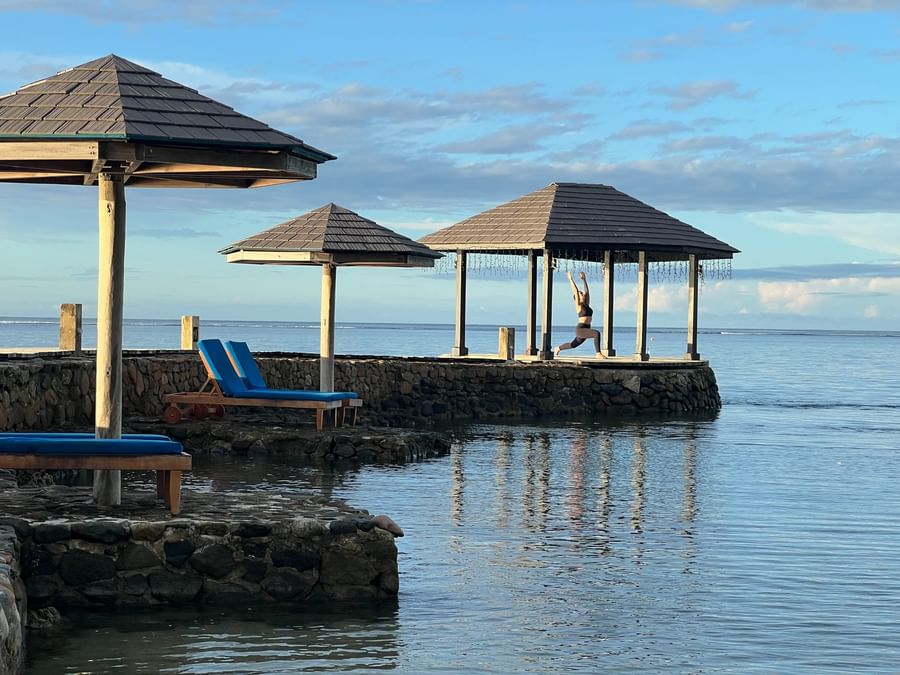 Woman doing yoga under a gazebo at Warwick Fiji Resort and Spa.