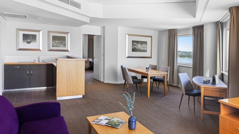 Superior Suite living room with kitchen, working desk, dining table, TV and sofa