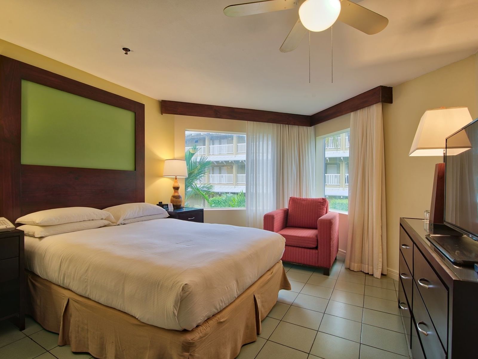 Interior view of Jr Suite Garden View Room with a king bed at Fiesta Resort