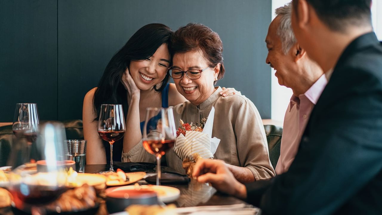mom holding daughters face and smiling