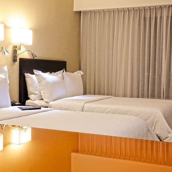Closeup of twin beds in Superior Room at Fiesta Inn