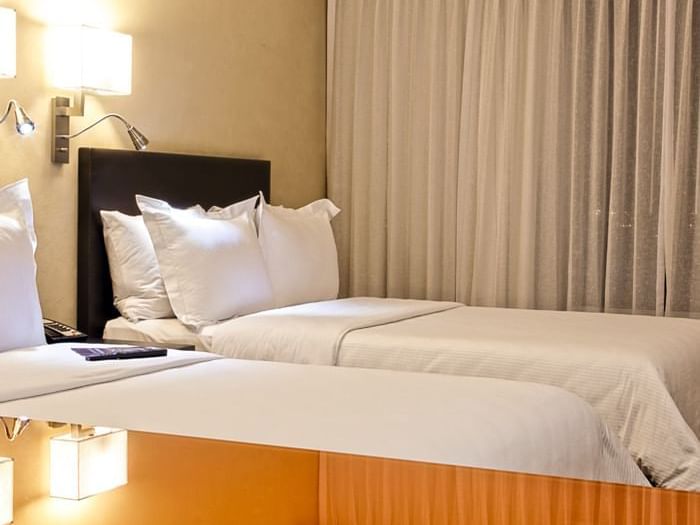 Closeup of twin beds in Superior Room at Fiesta Inn