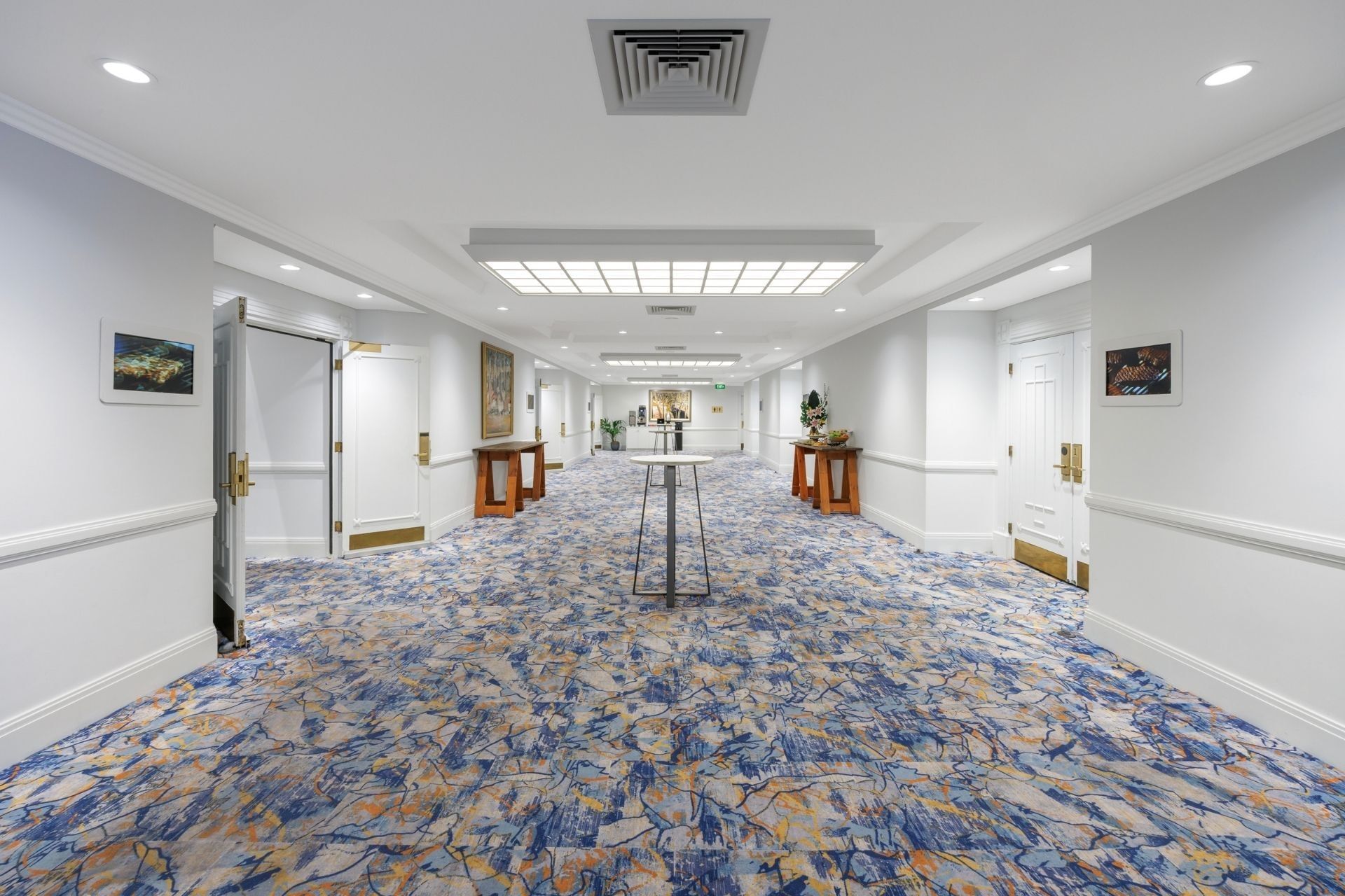 Pre-function with a round table at Hotel Grand Chancellor Adelaide