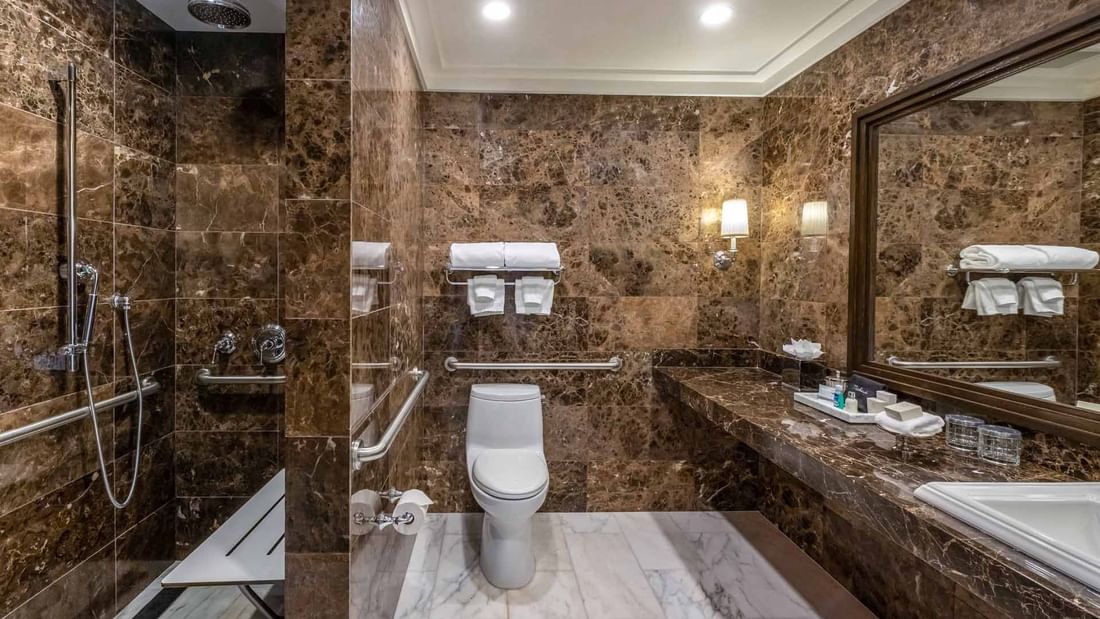 Bathroom interior with vanity and shower area in Deluxe King Mobility and Hearing Accessible at El Prado Hotel