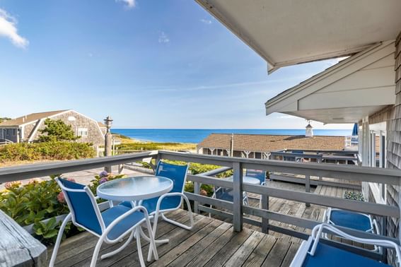 Terrace with outdoor chairs, canopies & sea view at Chatham Tides Resort