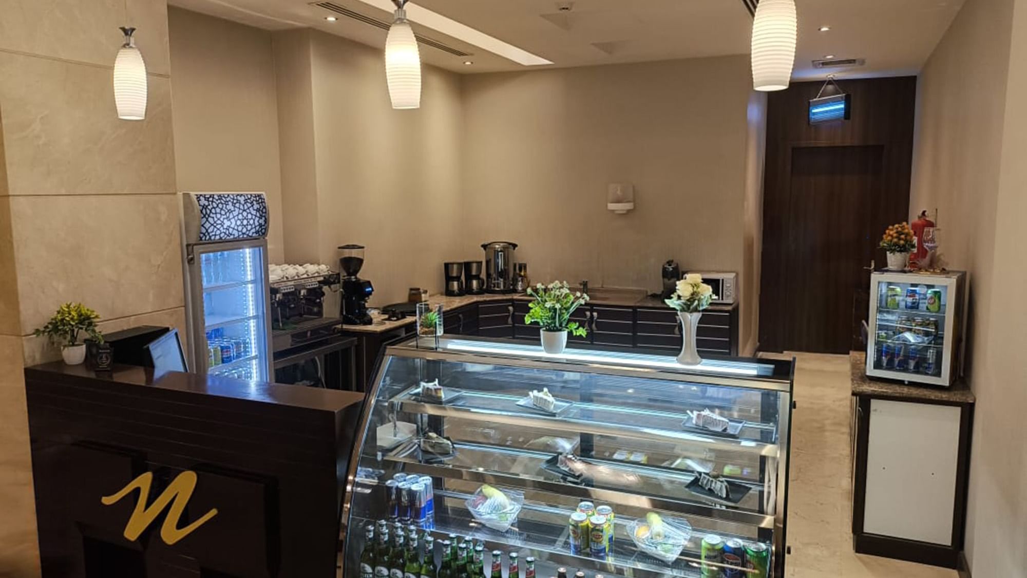 A case filled with pastries and bottled in Coffee shop at Warwick Hotels & Resorts