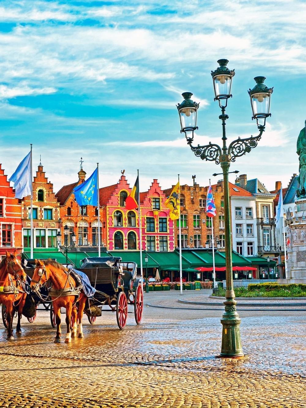 Colorful Grote Markt historic center with horse-drawn carriages located near Hotel Barsey by Warwick