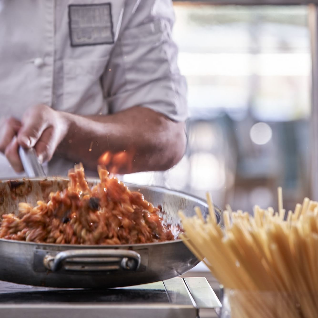 Close up of a chef preparing food in Socrates at Kiotari Resort