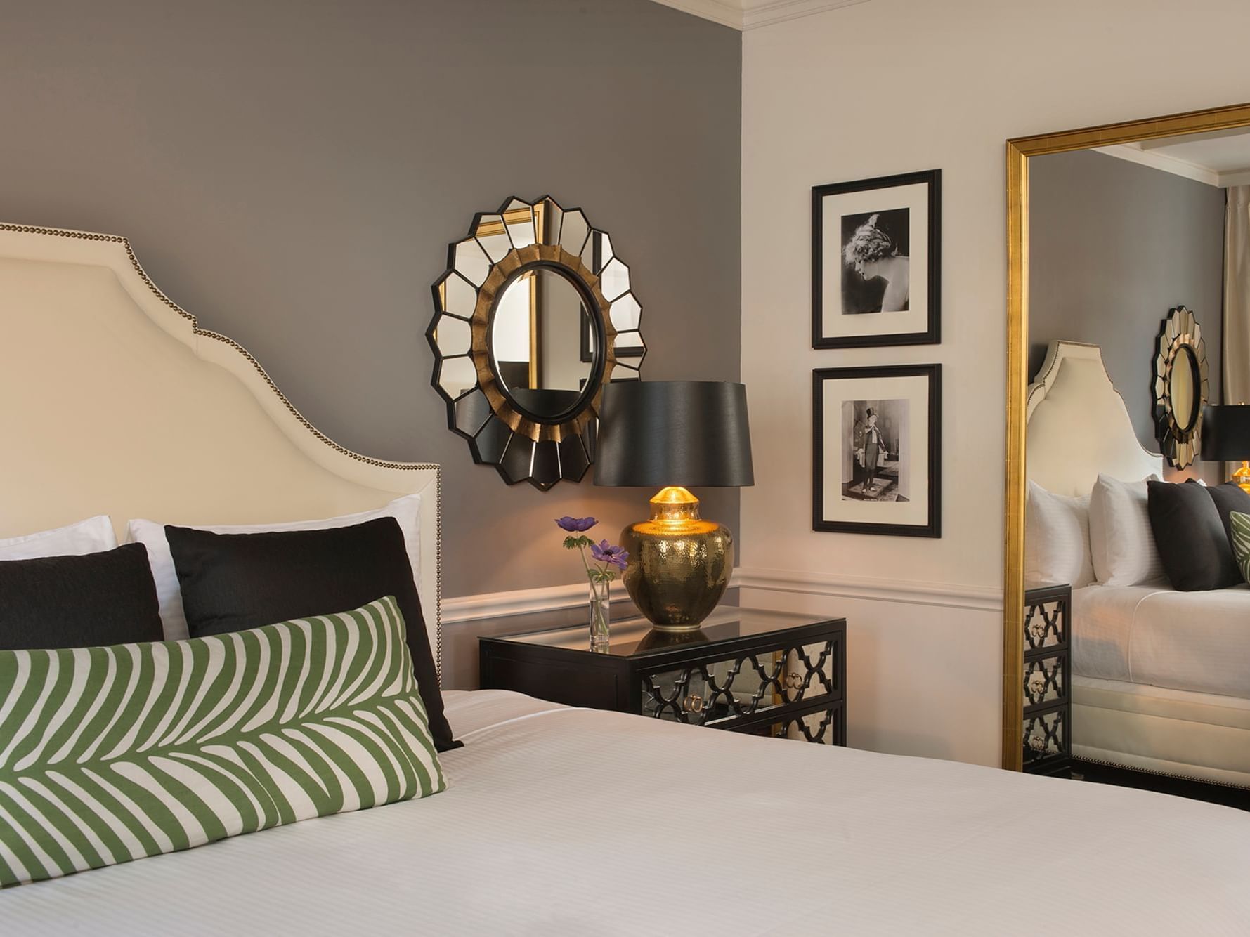 Comfy bed with side table and mirror in Marion Suite at Warwick New York