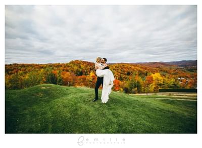A groom carrying bride near Hotel Mont Gabriel Resort & Spa