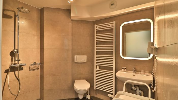 Shower & vanity in a suite bathroom at The Originals Hotels
