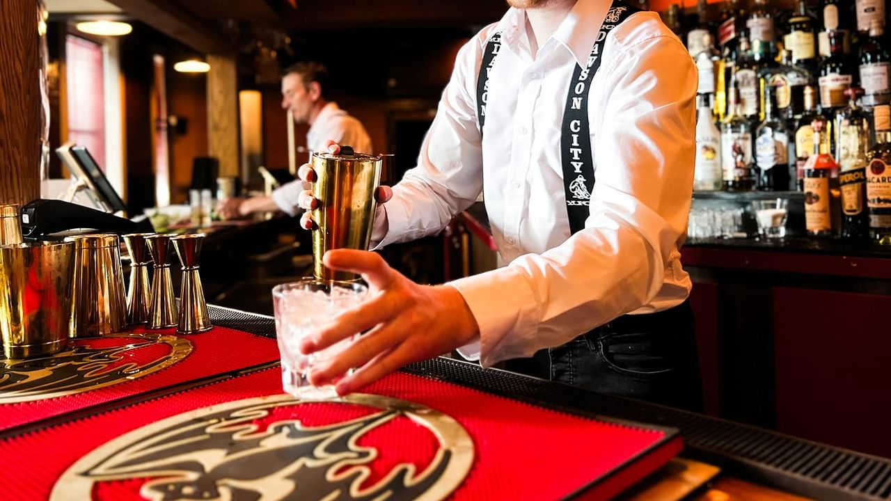 A bartender preparing a drink in a Sun Lounge at Midnight Sun, a Coast Hotel