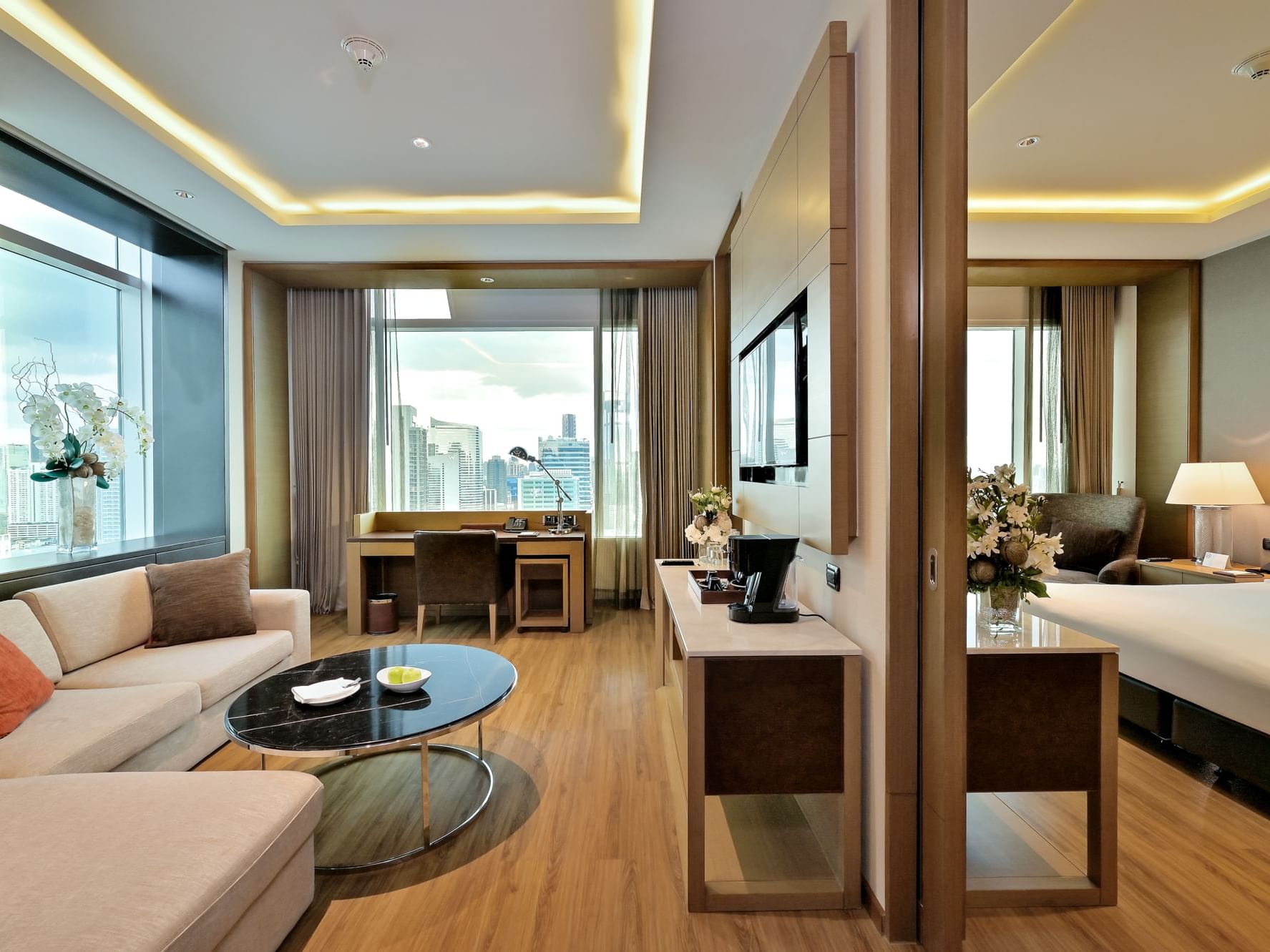 Junior Suite living area with city view at Eastin Hotels