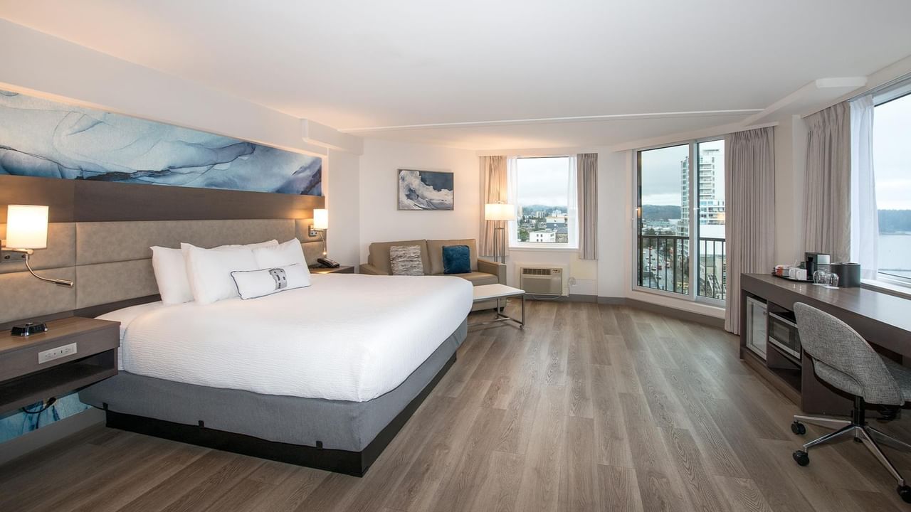King size bed and ocean view in a room at Coast Bastion Hotel in Nanaimo.