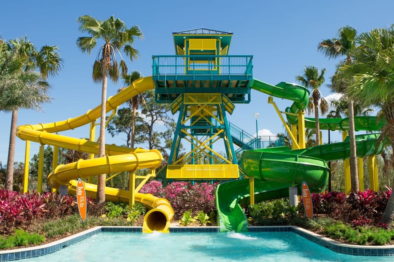 A colorful water park featuring a prominent slide and a curvy water slide at Surfari Water Park Resort
