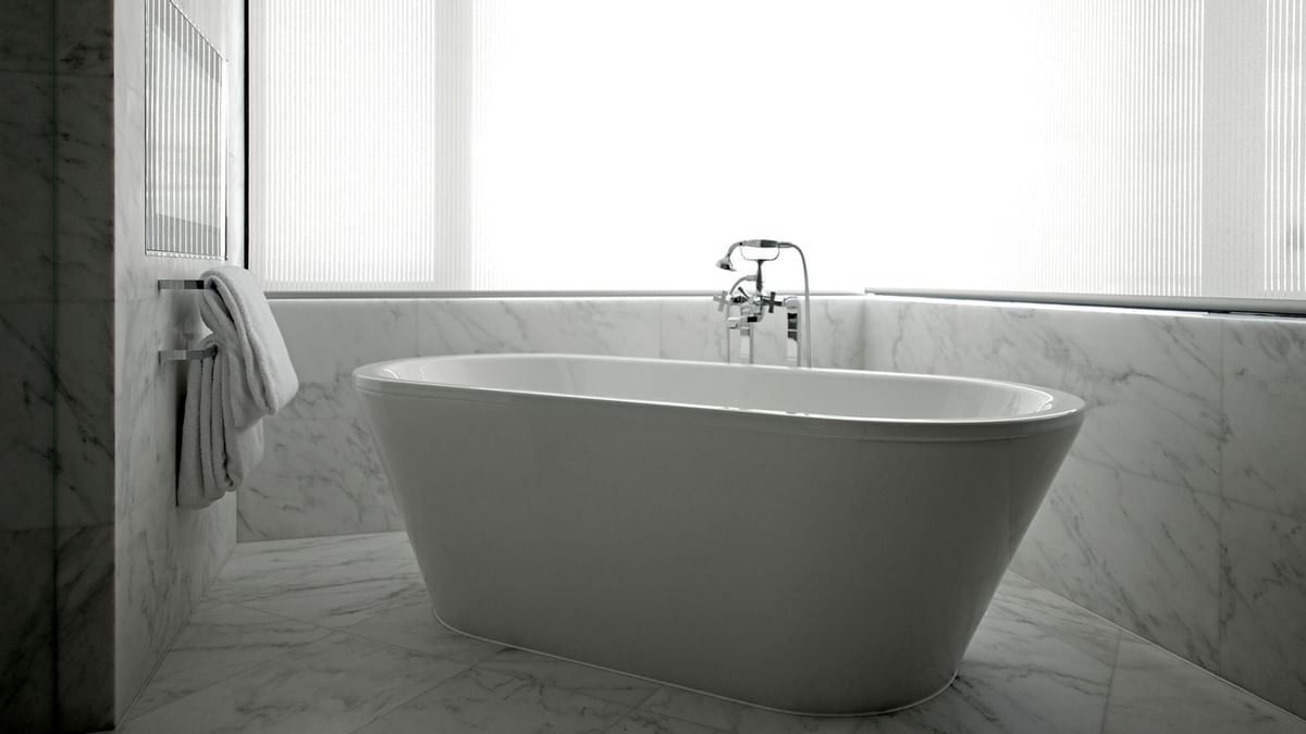 A bathtub in a bathroom in a suite at Crown Hotels Perth