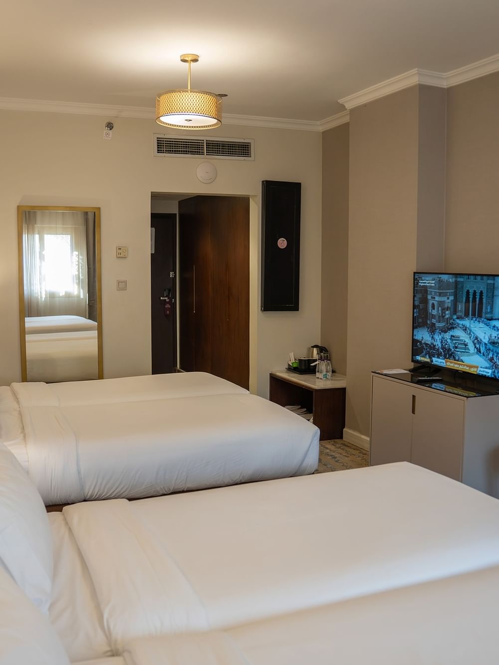 غرفة توأم تنفيذية فسيحة مزودة بأسرّة متعددة ووسائل راحة حديثة في فندق سجى ورويك المدينة المنورة.