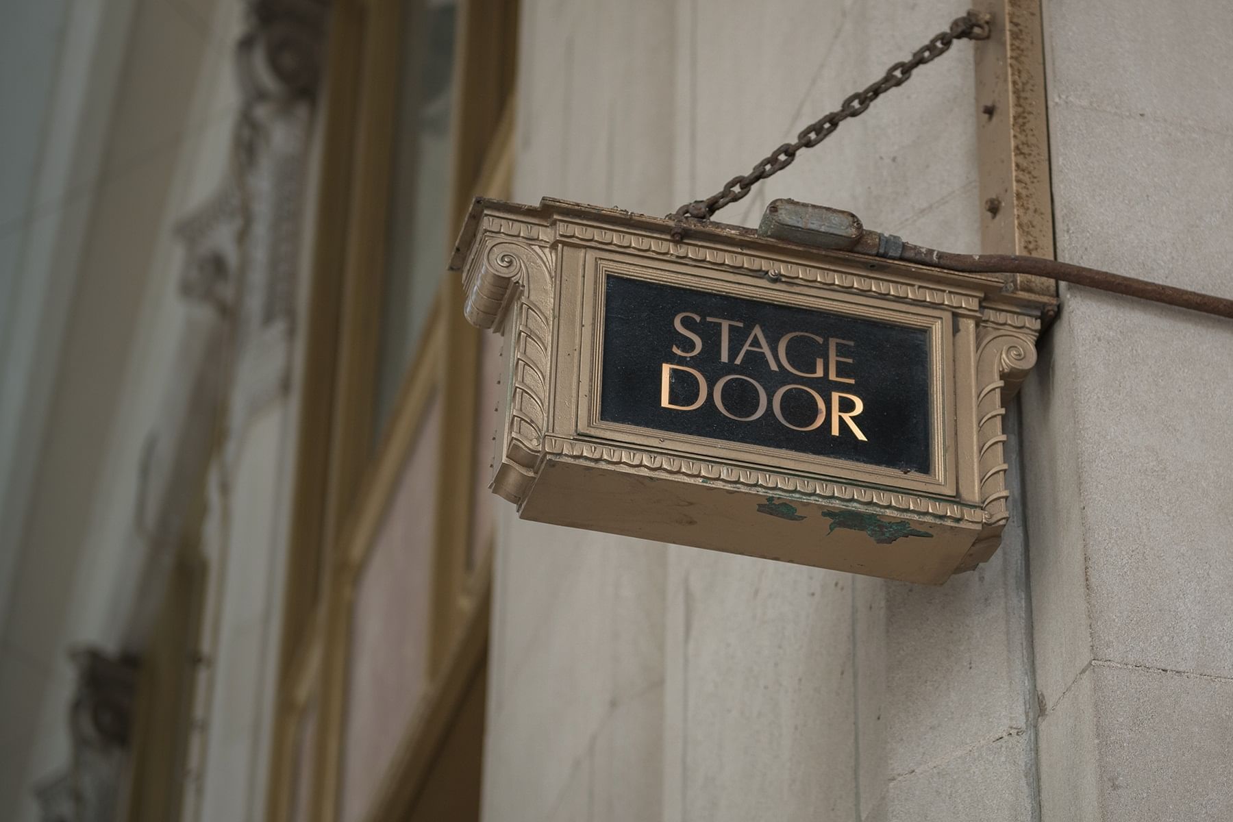 'Stage Door' sign hanging outside from a building at The Londoner