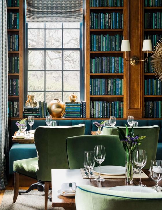 Bookshelves, comfy chairs, coffee tables & lamps in The Library at The Clifton