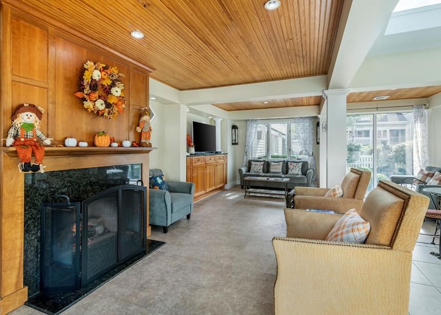A living area with TV and wooden stove at Ogunquit Collection