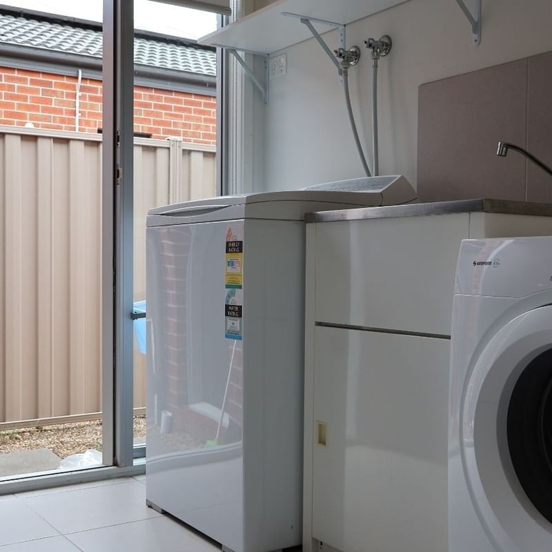 Laundry room with washing machine and dryer at La Trobe University Regional Housing.
