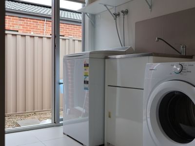 Laundry room with washing machine and dryer at La Trobe University Regional Housing.