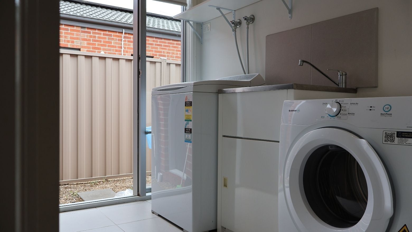 Laundry room with washing machine and dryer at La Trobe University Regional Housing.