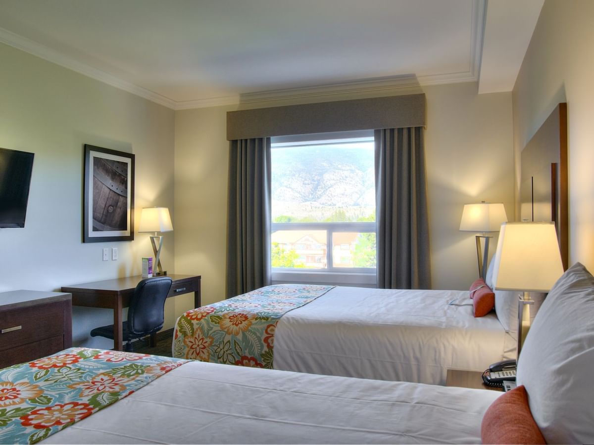 Two beds in hotel room with window