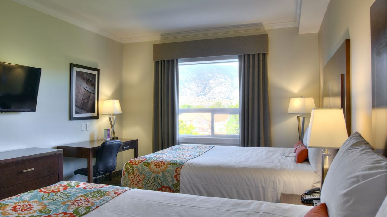 Two beds in hotel room with window