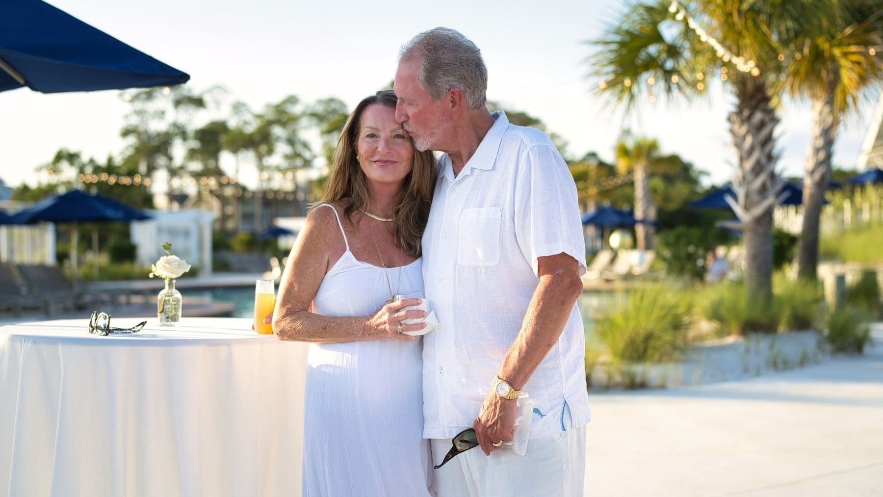 Couple standing close together near a table with drinks for Valentine’s Day Escape.