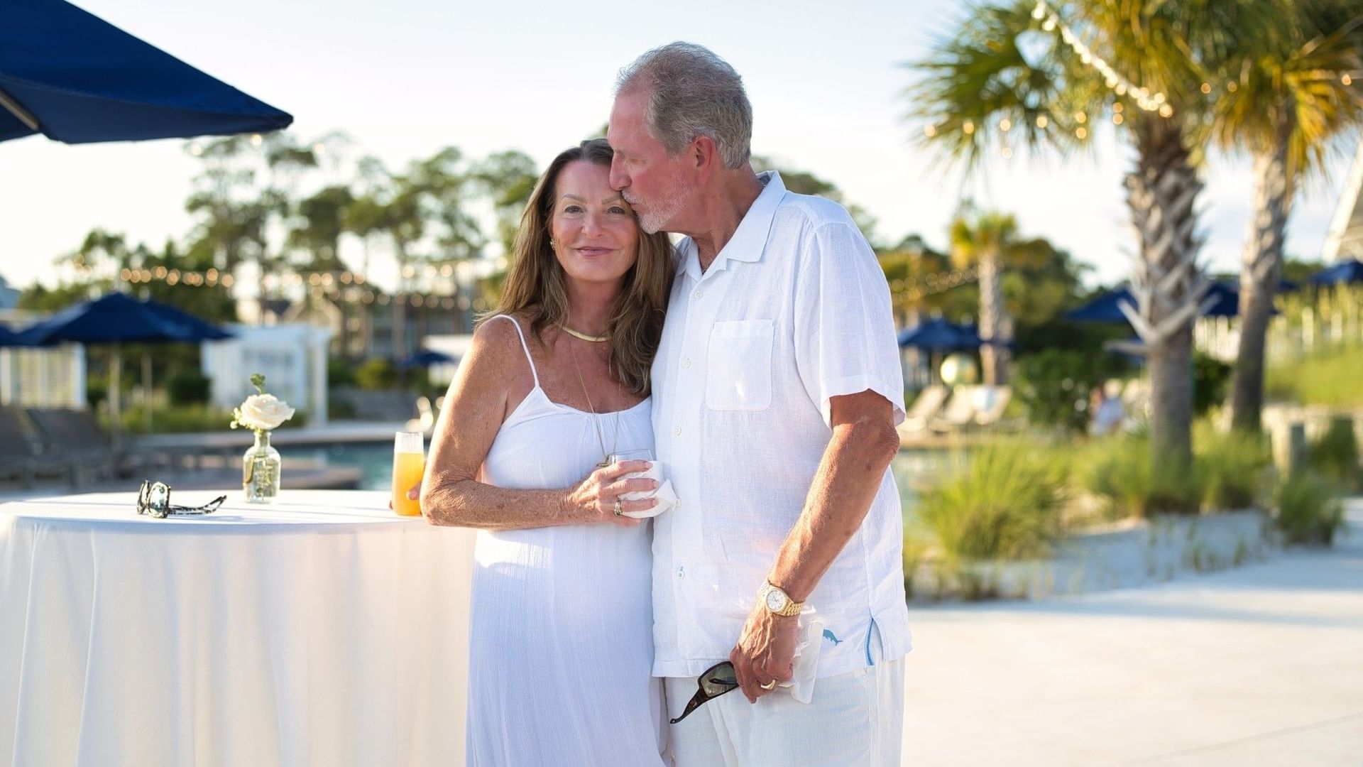 Couple standing close together near a table with drinks for Valentine’s Day Escape.