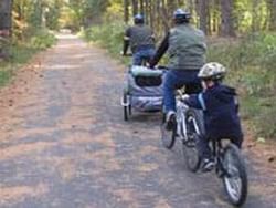 Family riding bicycles in Bruce Freeman Rail Trail near Westford Regency