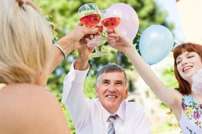 People enjoying drinks at their garden retirement party a Gorse Hill in Surrey 