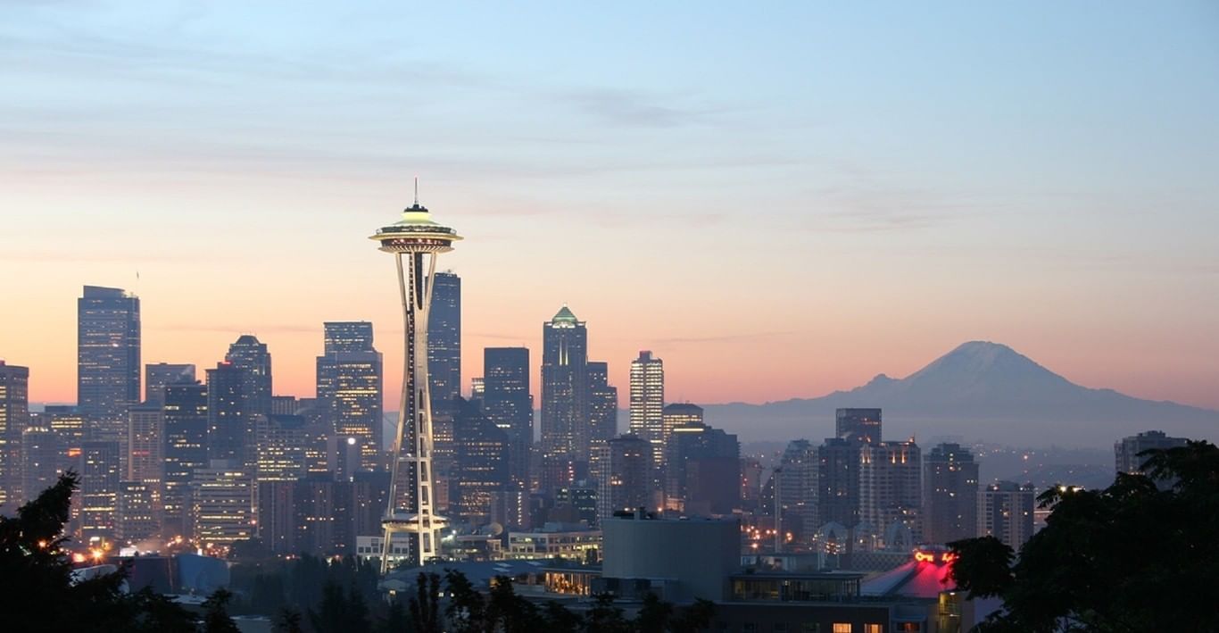 View of space needle and downtown Seattle with pink sunset and M
