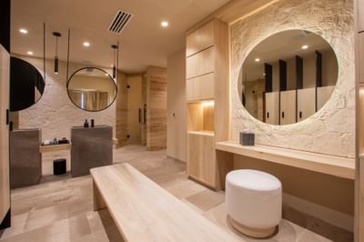 Bathroom interior with circular mirrors, concrete sinks, and wooden elements at Villa Premiere Boutique Hotel & Romantic Getaway