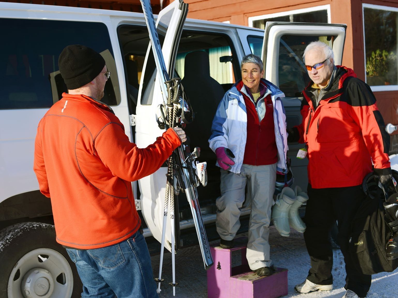 Three people getting ready to go skiing near Lutsen Resort