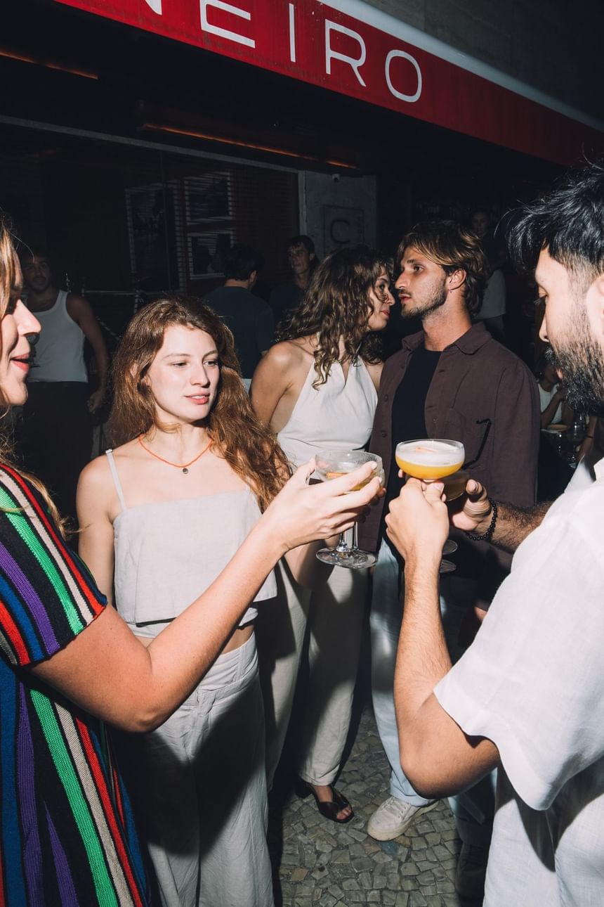Pessoas reunidas no Janeiro Bar no Leblon tomando drinks em uma noite de verão