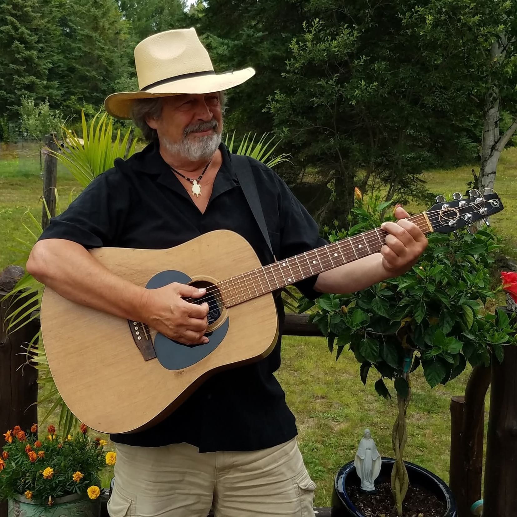 Wayne Failing in cowboy hat playing guitar at Trail's End.