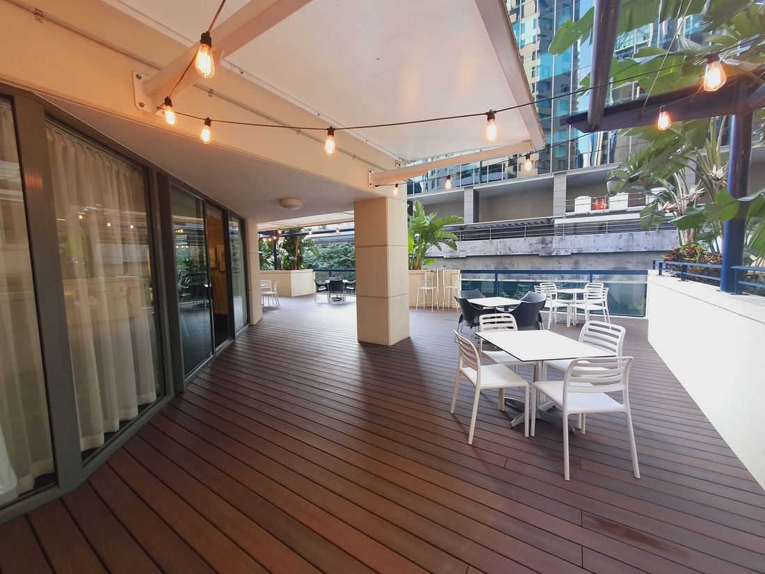 Terrace Albert Room with white tables, string lights, and city views, ideal for relaxing at The Sebel Brisbane