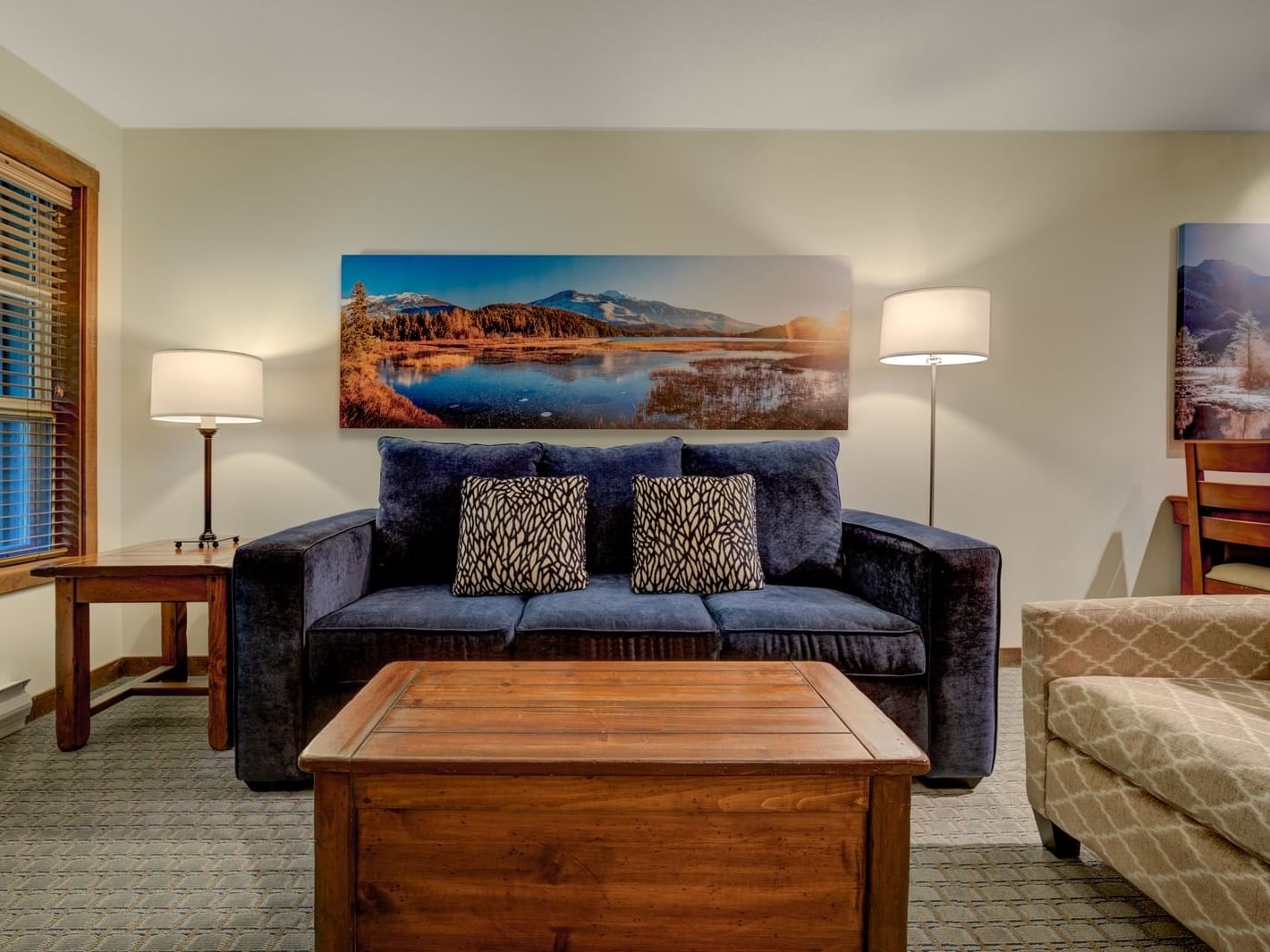 living room with blue sofa and wooden coffee table