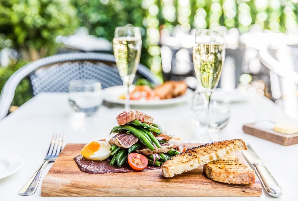 Closeup of a dish & champagne served at Crown Hotel Perth